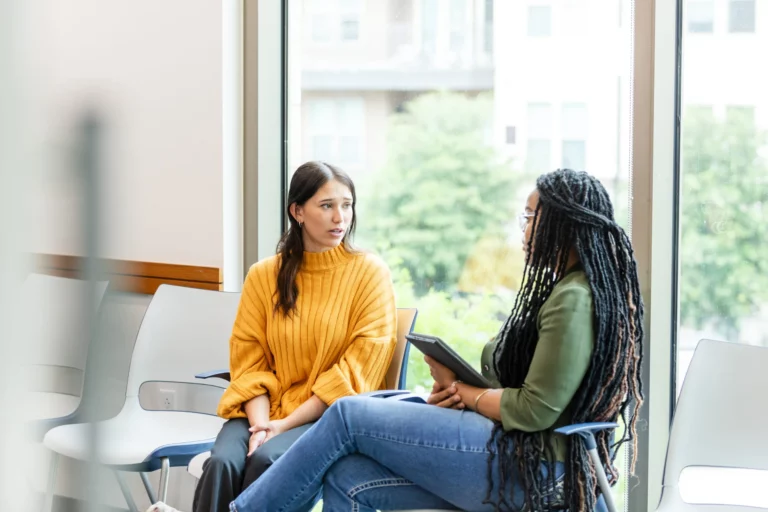 the-young-adult-woman-looks-worried-as-she-listens-to-the-unrecognizable-young-adult-female-therapist-stockpack-gettyimages-scaled-jpg